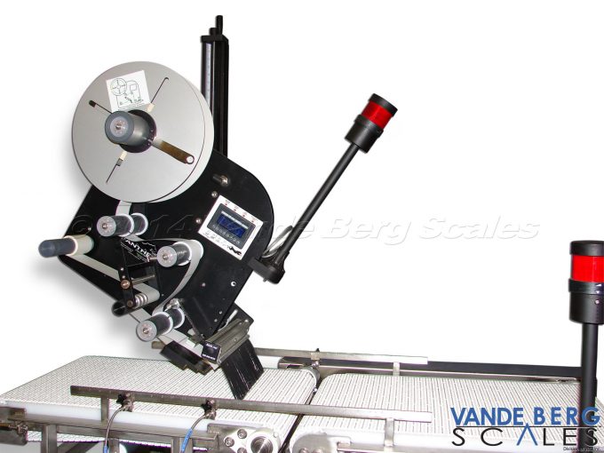 Top Labeler with alarm light and brush to ensure labels are firmly affixed.